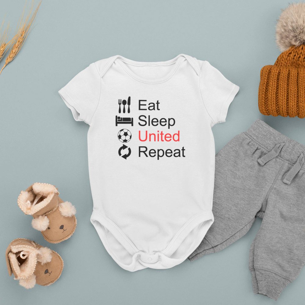 Flat lay of a white baby onesie with the phrase 