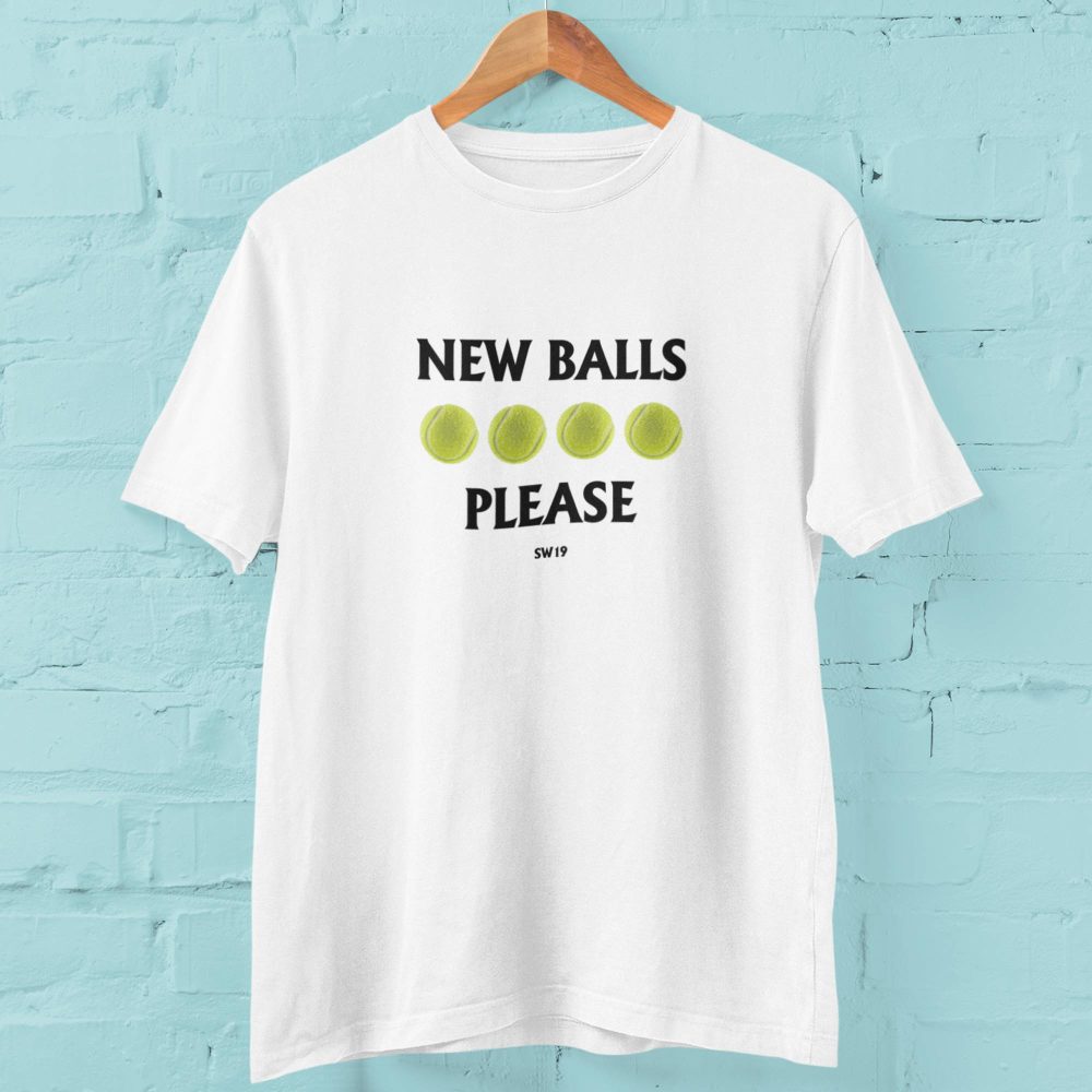 White tennis-themed T-shirt featuring the slogan “New Balls Please” with four tennis balls and SW19 text, inspired by British grass-court tennis tournaments and summer sporting events.